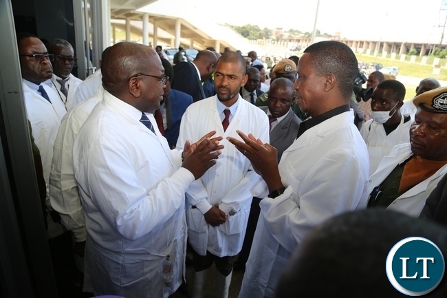 President Edgar Lungu confers with Minister of Health Chitalu Chilufya whilst Minister Local Government Vincent Mwale listens during the tour of Heroes Stadium Cholera centre