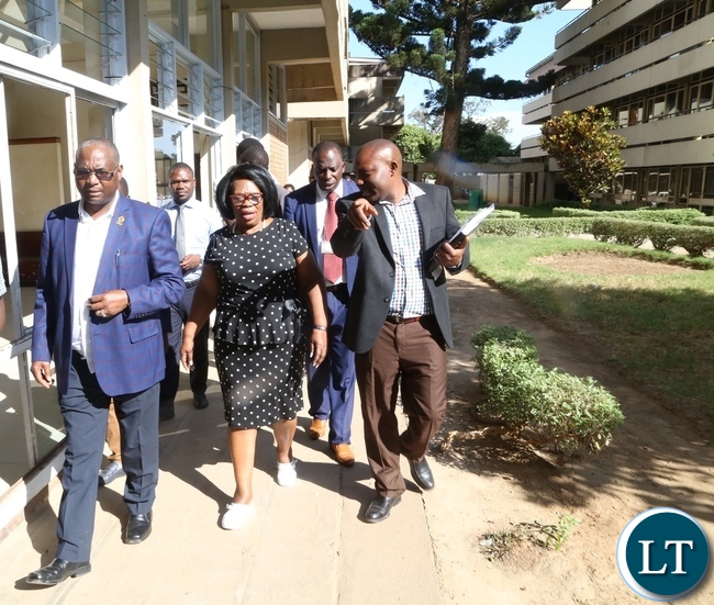 Minister of High Education Prof. Nkandu Luo (c) University of Zambia Vice Chancellor Prof. Luke Mumba (l) and University of Zambia Resident Engineer Ally Nyirenda during the tour and inspection of the hostels at UNZA