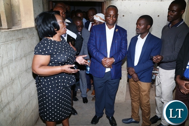 Minister of High Education Prof. Nkandu Luo confers with University of Zambia Vice Chancellor Prof. Luke Mumba during the tour to check on the clean up exercise whilst UNZASU representative Oscar Musukuma looks on
