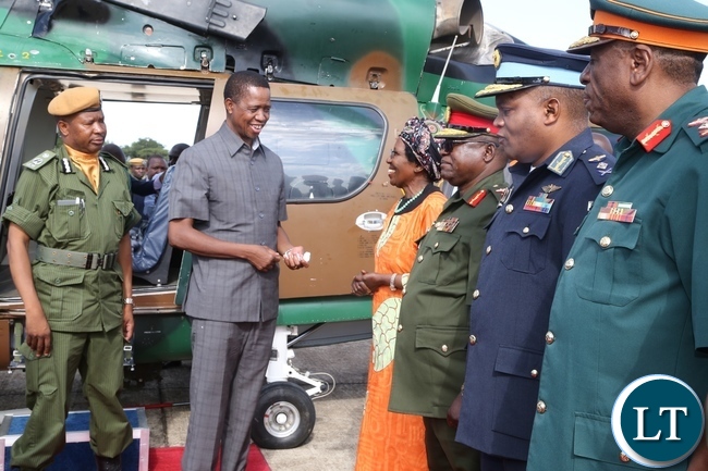 President Edgar Lungu confers with Vice President Inonge Wina at ZAF Lusaka shortly before his departure to Muchinga Province for three days working visit whilst Services Chiefs looks on
