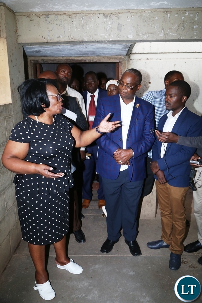 Minister of High Education Prof. Nkandu Luo confers with University of Zambia Vice Chancellor Prof. Luke Mumba during the tour to check on the clean up exercise whilst UNZASU representative Oscar Musukuma looks on