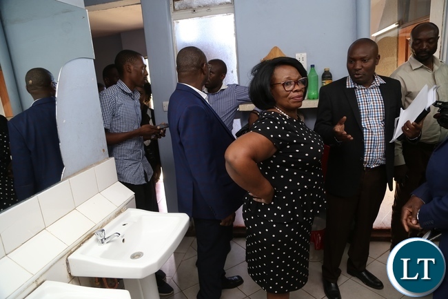 University of Zambia Resident Engineer Ally Nyirenda explaining to Minister of High Education Nkandu Luo the part of the water pipes the where removed during the clean up exercise due to cholera at University of Zambia