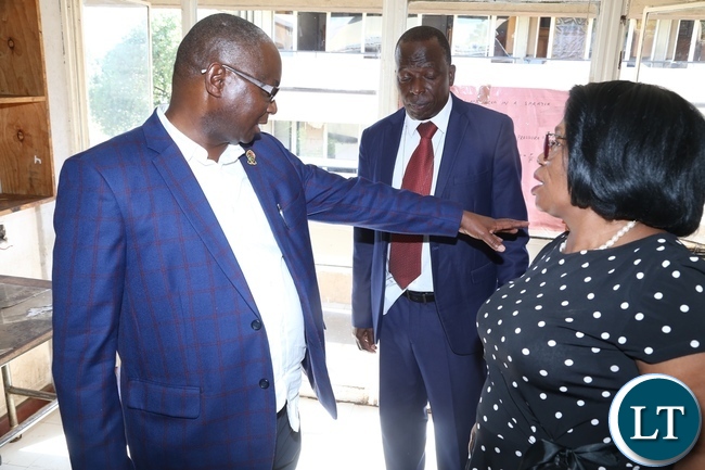 University of Zambia Vice Chancellor Prof. Luke Mumba confers with Minister of High Education Prof. Nkandu Luo during the tour to check on the clean up exercise in the hostels at UNZA