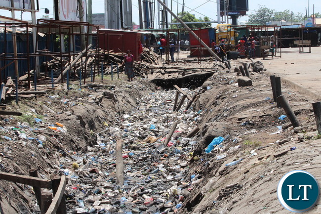 Lumumba drainage along City Market bus station before and after.