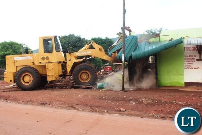 A Front end loader from Chipata City Council demolishes an illegal structure allegedly built on top of an Eastern Water and Sewerage Company water pipe near Kapata Market in Chipata. This was during a cleanup exercise to curb the spread of cholera in the district. PICTURE BY STEPHEN MUKOBEKO/ZANIS A Front end loader from Chipata City Council demolishes an illegal structure allegedly built on top of an Eastern Water and Sewerage Company water pipe near Kapata Market in Chipata. This was during a cleanup exercise to curb the spread of cholera in the district. PICTURE BY STEPHEN MUKOBEKO/ZANIS