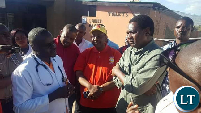 Mr Hichilema and top UPND officials receiving a brief from a Ministry of Health official during the tour of the Cholera centers.