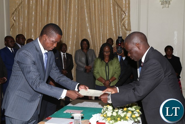 President Edgar Lungu receives a later of Oath from newly sworn in court of appeal Judge Justice Mwiinde Siavwapa at State House