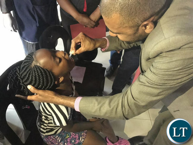 Minister of Local Government Vincent Mwale administering Cholera vaccine