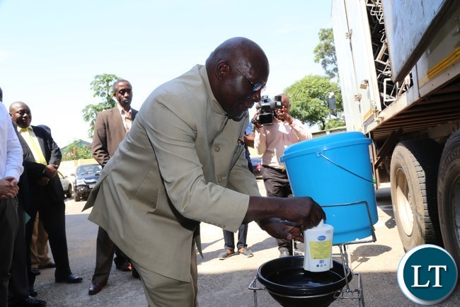 Minister of General Education Dennis Wanchinga hand washing after he flagged off the distribution of water,sanitation and hygiene wash materials in Lusaka