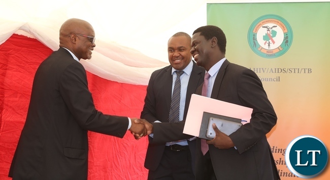 Acting Director General National AIDS Council Fortune Chibamba welcomes Ministry of Health Director Public Health Dr. Andrew Silumesii whilst AIDS Heath Foundation Country Director Dr. Mabvuto Kango during the International Condom Day at Central Mall