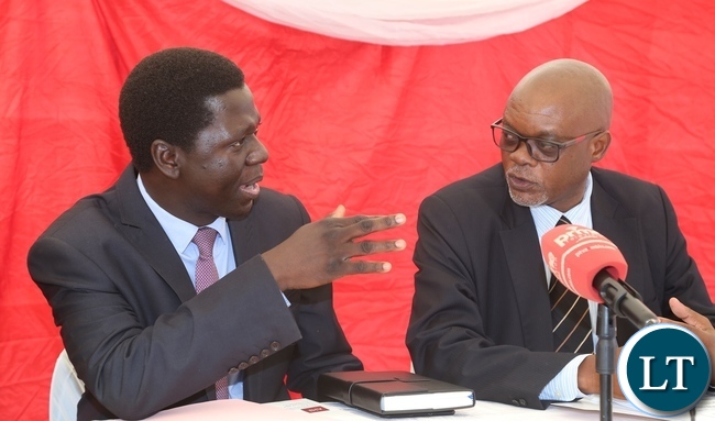Ministry of Health Director Public Health Dr. Andrew Silumesii confers with Acting Director General National AIDS Council Fortune Chibamba during the International Condom Day at Central Mall