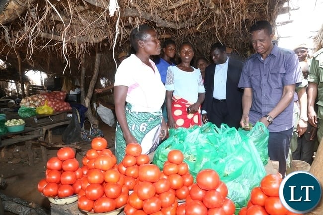 President Edgar Lungu buying vegetables at John Chinena during the tour of Chibombo District in Central Province