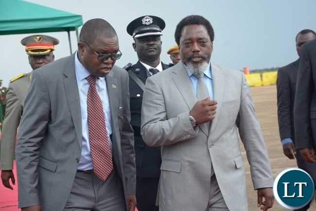 President Joseph Kabila confers Foreign Affairs Minister Joseph Malanji shortly before his departure at Kenneth Kaunda International Airport