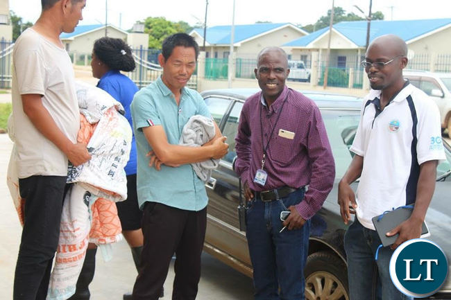 The two Chinese employees who were arrested for contravening the Environmental Management Act.
