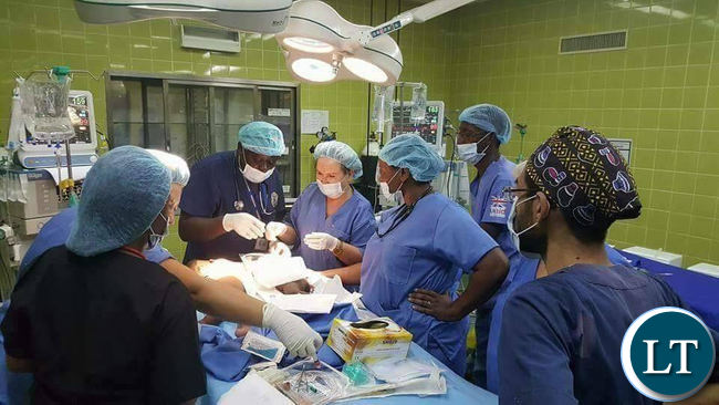 Surgeons performing the operation on conjoined twins