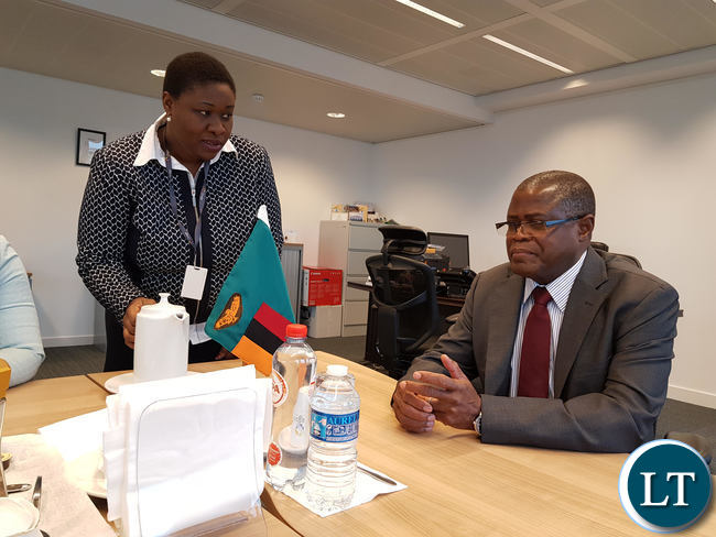 Commerce Minister, Christopher Yaluma being served by Mrs. Delphine Mundia, Second Secretary – Personal Assistant.