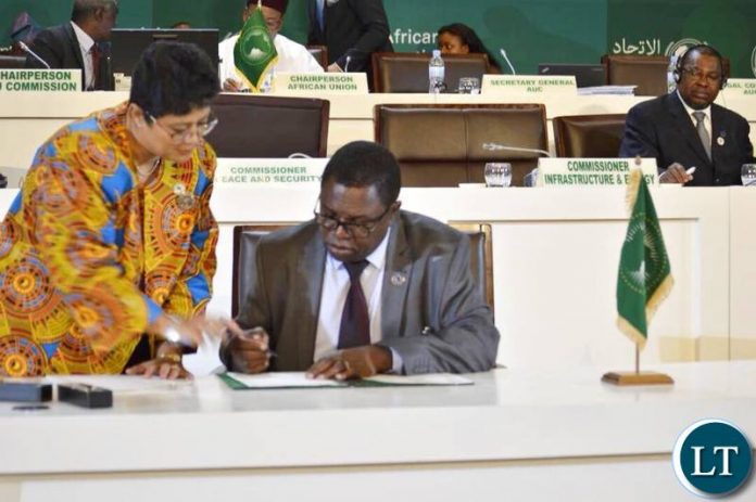 Foreign Affairs Minister Joe Malanji signing the declaration in Kigali, Rwanda