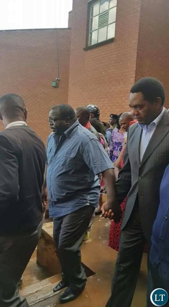 HH aids Kambwili to walk outside the Magistrate Court