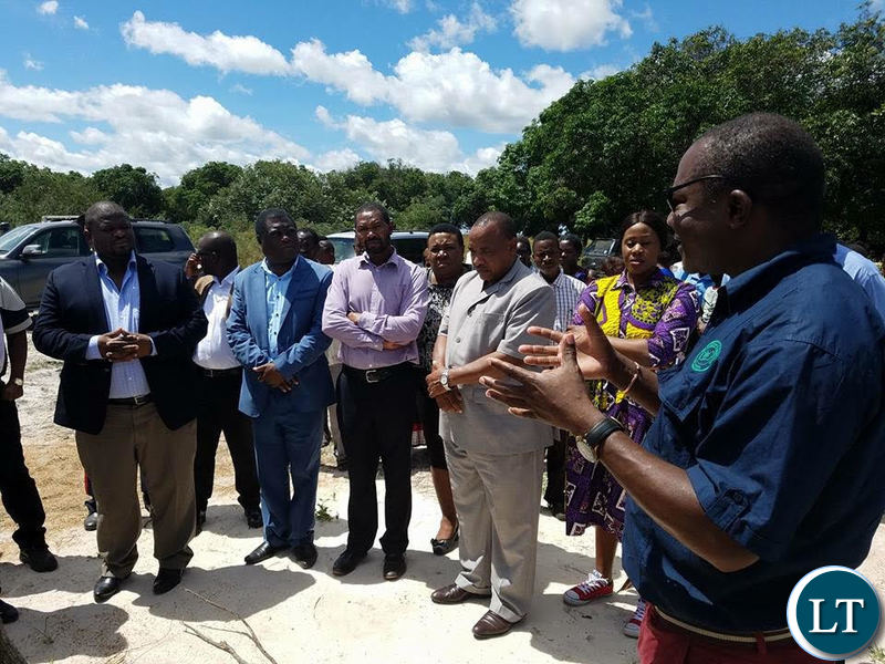 National Planning and Development Minister Alexander Chiteme inspects a cashew unit field looks in western province