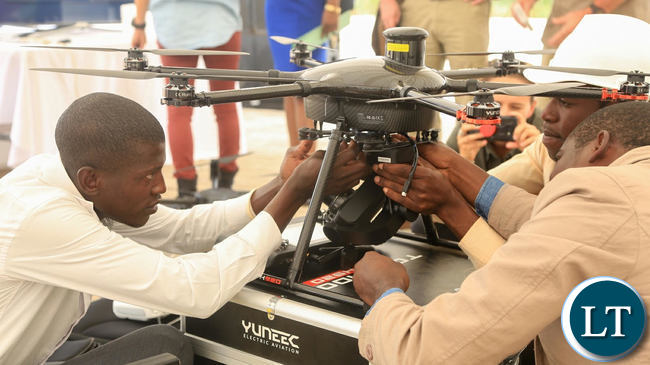 Technicians from SWUAT Technologies prepare a drone to take off.