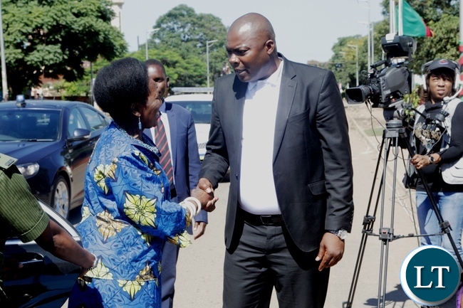 Vice President Inonge Wina is welcomed by Lusaka Province Minister Bowman Lusambo on arrival at the freedom statue for the international women's day commemoration
