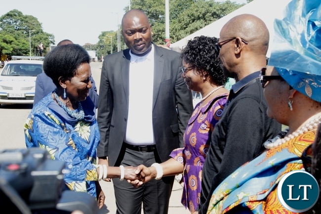 Vice President Inonge Wina is welcomed by 1st Deputy speaker of National Assembly Catherine Namugala on arrival at the freedom statue for the international women's day commemoration .looking on (center) is Lusaka Province Minister Bowman Lusambo