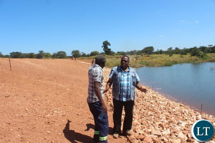 State house chief analyst for project implementation and monitoring Joseph Mukupa (Right) with site engineer Dalisto Shawa(left) during an inspection of the Katembula Earth Dam in Lufwanayama District earlier .picture By Noah Kangali(ZANIS)