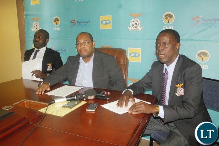 Outgoing FAZ General Secretary Ponga Liwewe (c) addressing a media briefing
