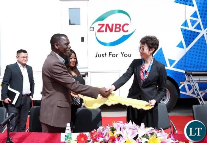 Zhao Yueqin, Vice President of StarTimes Group hands the key of OB and DSNG vans to Beaton Kaluba MIBS Planning and Information Director