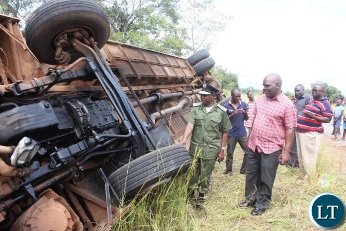 Part of the onlookers catches a glimpse of a Juldan coach Reg. No ABE 6940 which has claimed 4 lives after over turning due to allegedly failure by the driver to stop on the T-Junction along the Kasama- Luwingu road in the early hours of Monday. The driver is among the 3 men who died on the spot while one female died upon arrival at the Hospital.-Picture by Mary Bwembya (ZANIS). Part of the onlookers catches a glimpse of a Juldan coach Reg. No ABE 6940 which has claimed 4 lives after over turning due to allegedly failure by the driver to stop on the T-Junction along the Kasama- Luwingu road in the early hours of Monday. The driver is among the 3 men who died on the spot while one female died upon arrival at the Hospital.-Picture by Mary Bwembya (ZANIS).