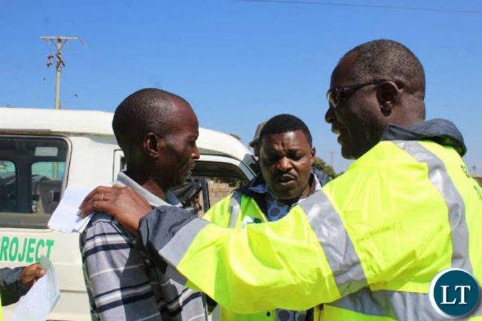 Works and Supply Minister Felix Mutati with Ministry Officials on the Street