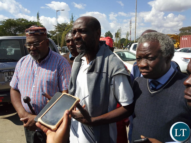 Mr Siwale (c) flanked by Mr Mulongoti and Mr Nason Msoni shortly after leaving court premises