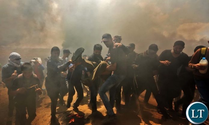Palestinians carry a demonstrator injured during the clashes. Photograph-Mahmud Hams-AFP-Getty Images Palestinians carry a demonstrator injured during the clashes. Photograph-Mahmud Hams-AFP-Getty Images