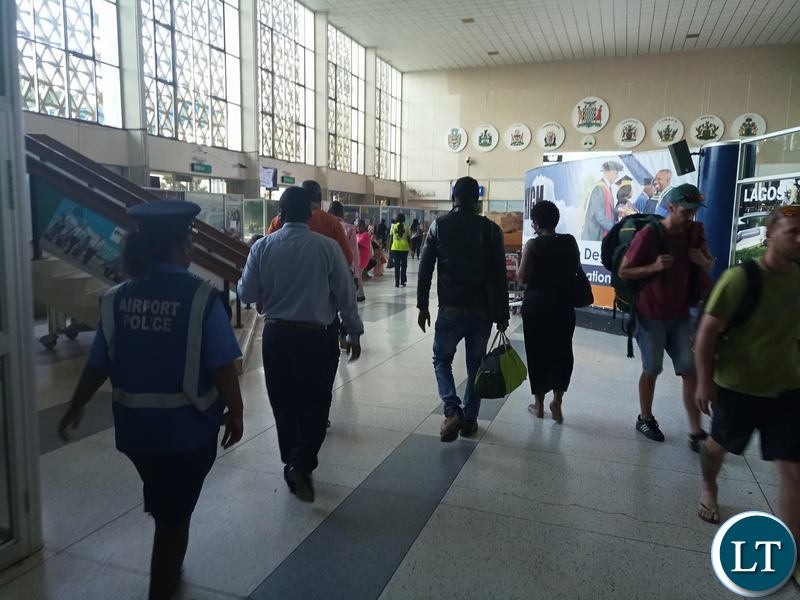 Pilato being led out of KKIA by plain clothed police officers