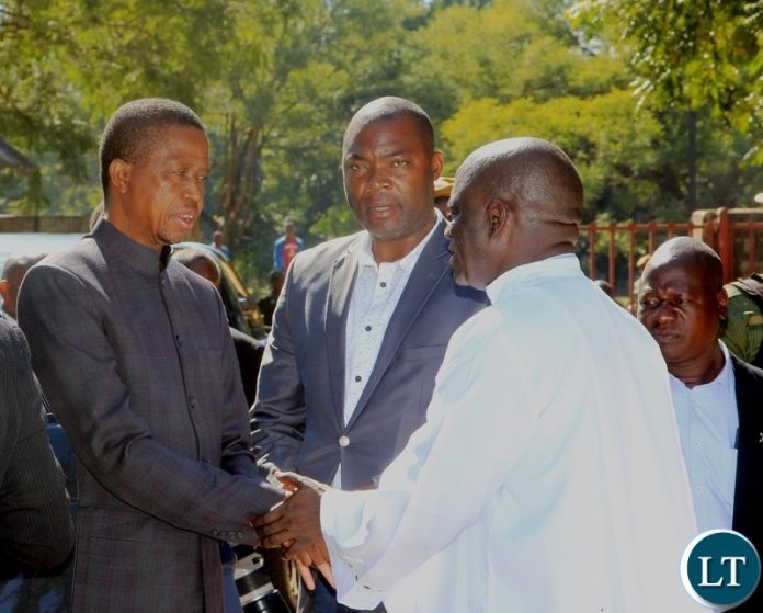 President Edgar Lungu is welcomed by Father Godfrey Mashilipa of Saint Marys Assumption Parish on arrival for a church service in Chilanga. Looking on (center)is Lusaka Province Minister Bowman Lusambo