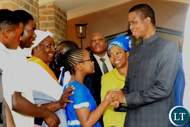 President Edgar Lungu greets a girl after a church service at Saint Marys Assumption Parish in Chilanga.looking on (center) is PF chilanga Constituency member of Parliament candidate Mrs Mary Langa