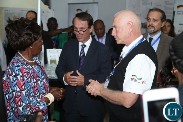 Vice President Inonge Wina confers with Corad Thombansen whilst Germany Ambassador Achim Burkart listens during the tour of stands shortly after the official opening of Zambia Water Forum and Exhibition at Government Complex yesterday 11-06-2018. Picture by ROYD SIBAJENE/ZANIS