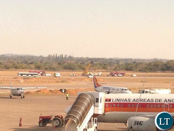 Airport authorities using a large crane to lift a plane off a runway at Kenneth Kaunda International Airport in Lusaka Airport authorities using a large crane to lift a plane off a runway at Kenneth Kaunda International Airport in Lusaka