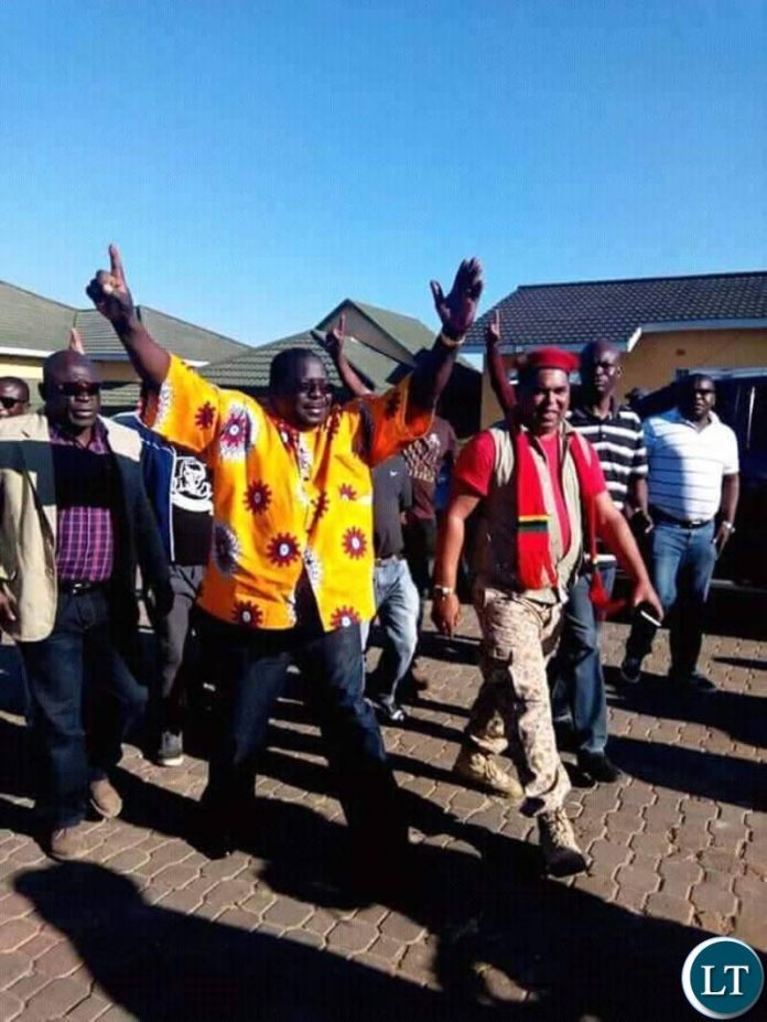 Kambwili flashes an NDC and UPND symbol