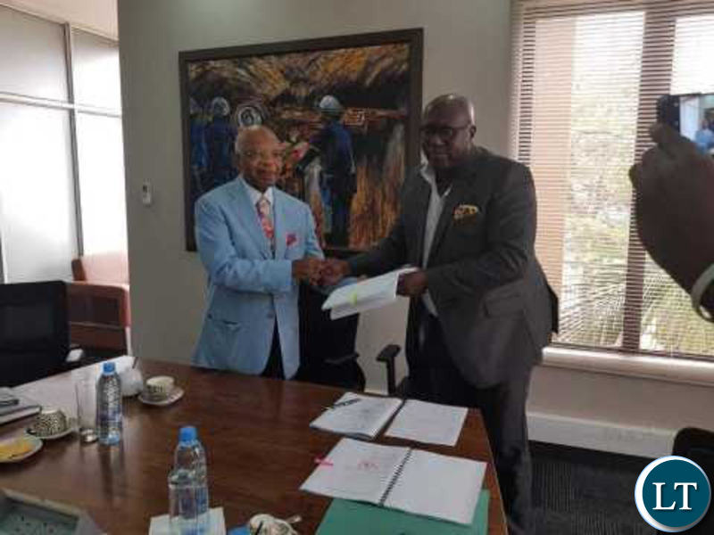 ZCCM IH CEO Pius Kasolo signs with a representative from Oranto Petroleum.