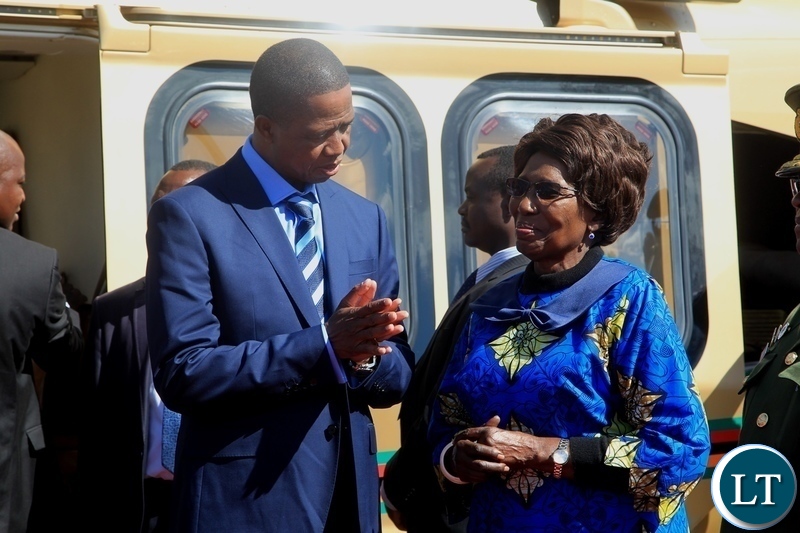 President Edgar Lungu confers with Vice President Inonge Wina before departure for Kenya for a private visit at Kenneth Kaunda International Airport