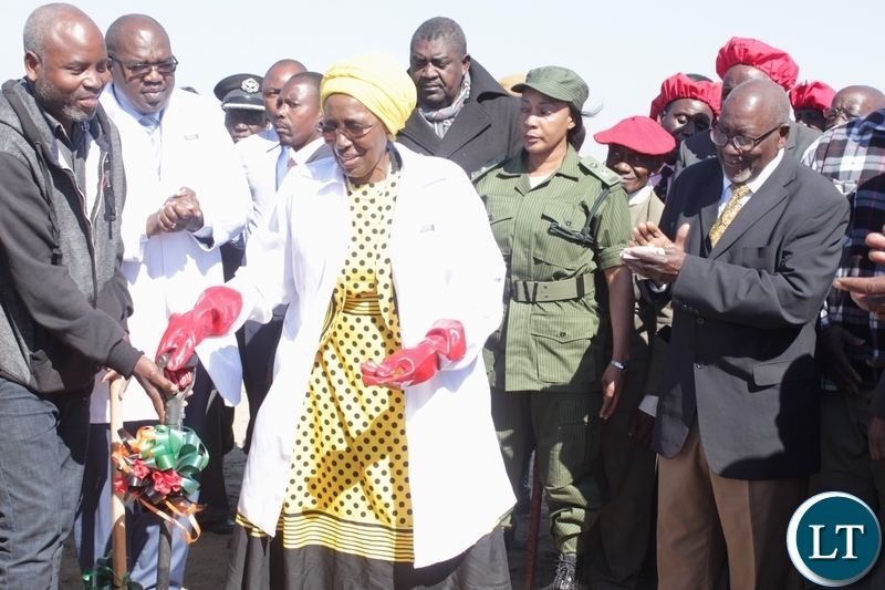 Vice President Inonge Wina (c) receives a shovel to do the ground breaking as Barotse Royal Establishment (BRE) Ngambela (Prime Minister) Mwenda Nyambe (r) looks on during the ground breaking ceremony for the proposed construction site of Lealui Mini Hospital in Mongu
