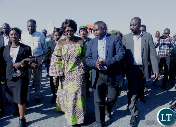 Vice President Inonge Wina (L) paying attention to Mongu District Administrative Officer Fredrick Inambao Lubasi (R) upon arrival at Mongu Airport for ground breaking ceremony of a Modern Clinic in Lealui Ward and Inspect progress on the Cashew Infrastructure Development Project (CIDP) in Western Province.