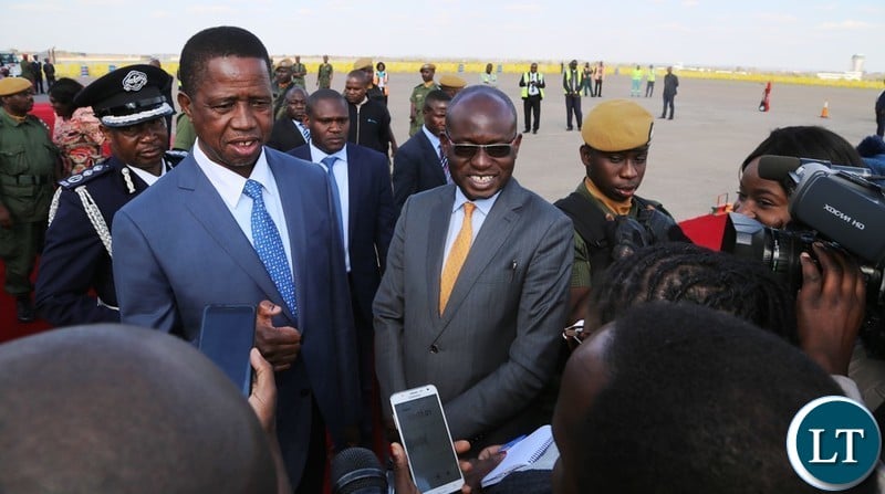President Edgar Lungu flanked by Special Assistant to President for Press and Public Relation Amos Chanda showing Journalists the thumb that he has voted too shortly before his departure for South Africa at Kenneth Kaunda International Airport