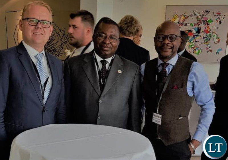 Dr Albert Muchanga shares a moment with Ambassador Anthony Mukwita and a German businessman.