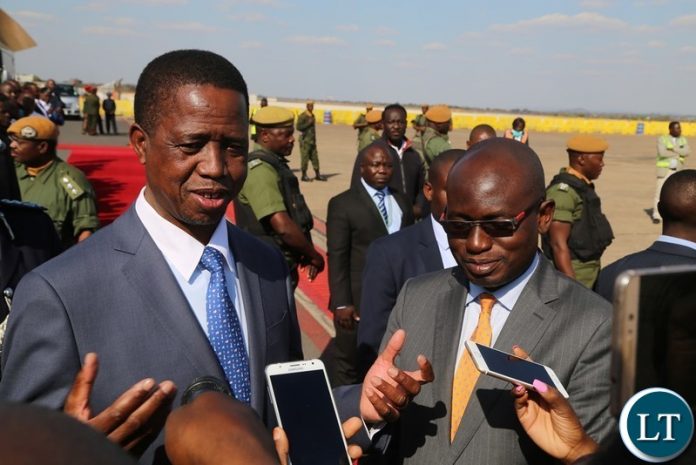 President Edgar Lungu flanked by Special Assistant to President for Press and Public Relation Amos Chanda speaking to Journalists shortly before his departure for South Africa at Kenneth Kaunda International Airport