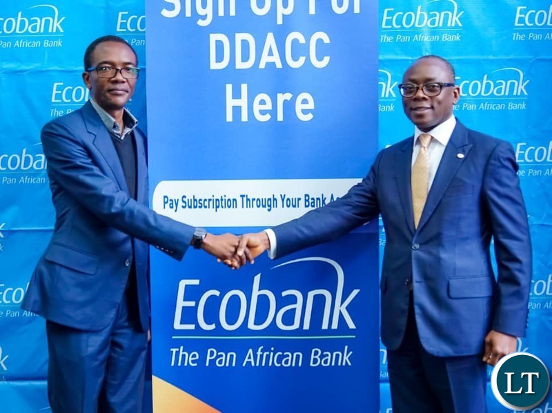 Ecobank Zambia Managing Director Kola Adeleke (R) shakes hands with Topstar Zambia Vice President Cliff Sichone after signing the agreement