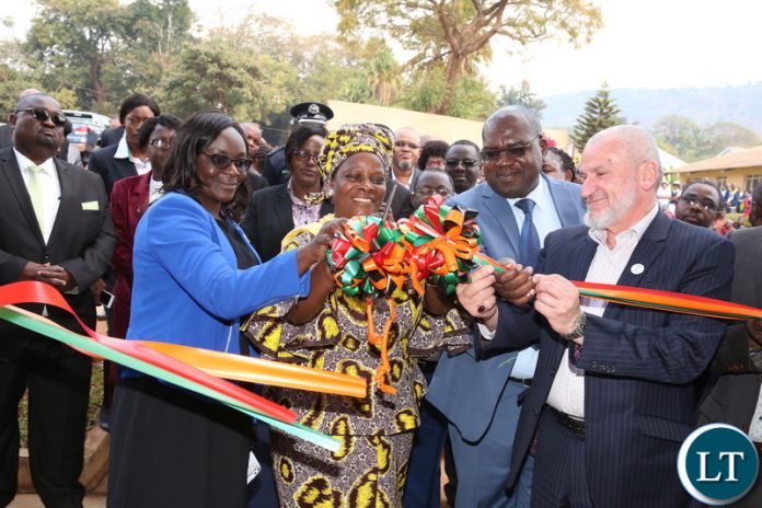 First Lady Esther Lungu cuts a ribbon with IIROSA Regional Director -Southern Africa Sheikh Walid R. EL Saadi and Health Minister Dr Chitalu Chilufya during the Commissioning of the eye hospital at Chipata Central Hospital, where she also launched an eye camp set by the Esther Lungu Foundation Trust in partnership with the International Islamic Relief Organization for Southern Africa (IIROSA) and the Ministry of Health on Tuesday, July 10,2018 -Picture by THOMAS NSAMA
