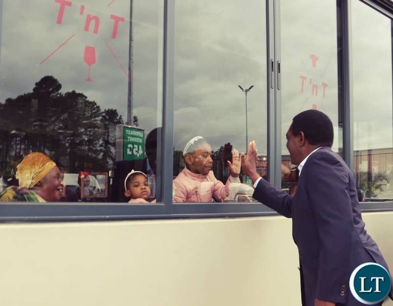 HH with a child outside a restaurent in Lusaka