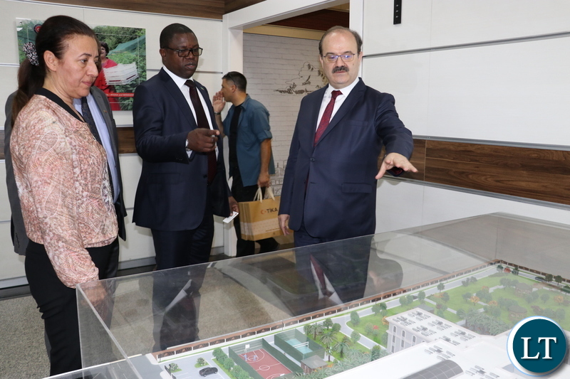 Turkish Cooperation and Coordination Agency (TIKA) President, Dr Serdar Cam shows a miniature building of a school project undertaken by TIKA to Minister of Foreign Affairs , Joseph Malanji in Ankara yesterday-Picture by JERRY MUNTHALI
